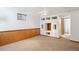 Finished basement with wood paneling, a custom shelving unit, and carpeted floors at 9652 Cove Creek Dr, Highlands Ranch, CO 80129