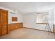 Carpeted basement area with paneled walls, windows, closet, and a floor lamp, offering cozy extra space at 9652 Cove Creek Dr, Highlands Ranch, CO 80129