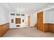 Spacious basement featuring wood paneling, carpet, custom storage, and access to additional areas at 9652 Cove Creek Dr, Highlands Ranch, CO 80129
