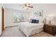 Inviting bedroom featuring a large window, plush bedding, and tasteful decorations at 9652 Cove Creek Dr, Highlands Ranch, CO 80129