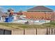 Community pool and water park with slide and seating area at 9652 Cove Creek Dr, Highlands Ranch, CO 80129
