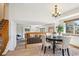 Cozy dining area featuring a modern chandelier, four chairs and view of the living room at 9652 Cove Creek Dr, Highlands Ranch, CO 80129