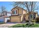 Charming two-story home with a well-manicured lawn and attached garage at 9652 Cove Creek Dr, Highlands Ranch, CO 80129