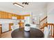 Kitchen adjacent to the stairs and dining area with oak cabinets at 9652 Cove Creek Dr, Highlands Ranch, CO 80129