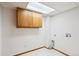A laundry room with cabinets and washer dryer hookups provides functionality and storage at 9652 Cove Creek Dr, Highlands Ranch, CO 80129