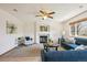 Inviting living room with a fireplace, ceiling fan, and natural light at 9652 Cove Creek Dr, Highlands Ranch, CO 80129