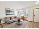 Bright living room showcasing a bay window, wood floors, and stylish seating arrangement at 9652 Cove Creek Dr, Highlands Ranch, CO 80129