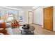Bright living room featuring a cozy chair, a bay window and hardwood flooring at 9652 Cove Creek Dr, Highlands Ranch, CO 80129