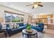 Bright living room with large windows, hardwood floors, and stylish blue sofas at 9652 Cove Creek Dr, Highlands Ranch, CO 80129