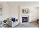Cozy living room with a fireplace and comfortable armchair with throw pillows at 9652 Cove Creek Dr, Highlands Ranch, CO 80129