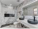 Modern bathroom featuring double sinks, unique wall tile design and a luxurious walk-in shower at 2545 S Leyden St, Denver, CO 80222