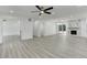 Inviting open-concept living room with sleek flooring and white accents, leading to bedroom at 2545 S Leyden St, Denver, CO 80222