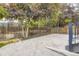 Large concrete patio framed by trees, shrubs and wood fence at 940 Kearney St, Denver, CO 80220