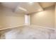 Basement features neutral paint, plush carpet, and access to additional rooms at 940 Kearney St, Denver, CO 80220
