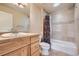 Bathroom features a vanity with granite countertop and a shower and tub combination at 940 Kearney St, Denver, CO 80220
