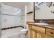 Updated bathroom boasts granite counters, wood cabinetry, and glass enclosed shower at 940 Kearney St, Denver, CO 80220