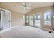 This bedroom features vaulted ceilings, a ceiling fan, and access to a private balcony at 940 Kearney St, Denver, CO 80220
