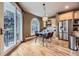 Bright breakfast nook with large windows, a modern table, and access to an outdoor patio for relaxing dining experiences at 940 Kearney St, Denver, CO 80220