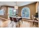 Sunlit dining room features modern light fixture, seating for four, and french doors leading to outdoor space at 940 Kearney St, Denver, CO 80220