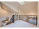 Bright hallway features an overlook to the living room and natural light from a skylight at 940 Kearney St, Denver, CO 80220