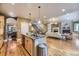 Open-concept kitchen island with granite countertops, stainless steel appliances, and seamless flow to other living spaces at 940 Kearney St, Denver, CO 80220