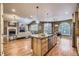 Spacious kitchen featuring granite countertops, a central island, and an open layout connecting living and dining areas at 940 Kearney St, Denver, CO 80220