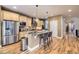 Modern kitchen with stainless steel appliances, granite countertops, and a functional island with barstool seating at 940 Kearney St, Denver, CO 80220
