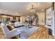 Open-concept living room showcases hardwood floors, fireplace, and views of the kitchen at 940 Kearney St, Denver, CO 80220