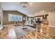 Inviting living room with hardwood floors, large windows, and a stylish chandelier, adjacent to an open-concept kitchen at 940 Kearney St, Denver, CO 80220
