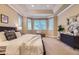 Spacious main bedroom offers tray ceilings, sitting area, and ample natural light with neutral color palette at 940 Kearney St, Denver, CO 80220