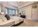 Bright main bedroom offers tray ceiling, many windows, and view of ensuite bathroom and closet at 940 Kearney St, Denver, CO 80220