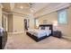 Large main bedroom includes tray ceilings, ensuite bathroom, neutral decor, and ample natural light at 940 Kearney St, Denver, CO 80220