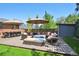 Spacious backyard deck features plush outdoor seating, a dining table, and two large umbrellas at 2774 S Milwaukee St, Denver, CO 80210