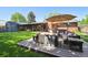Backyard wood deck with an outdoor living area including a fire pit, seating, and dining table at 2774 S Milwaukee St, Denver, CO 80210