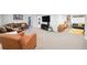 Wide angle shot of the finished basement with a large sectional, TV, and playroom area at 2774 S Milwaukee St, Denver, CO 80210