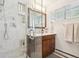 Updated bathroom with glass shower, vanity, and built-in storage niches at 2774 S Milwaukee St, Denver, CO 80210