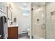 Bathroom features a glass door shower, white tile walls, and a modern vanity at 2774 S Milwaukee St, Denver, CO 80210