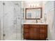Bright bathroom features a glass shower, vanity, and tiled walls at 2774 S Milwaukee St, Denver, CO 80210
