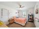 Bedroom with a ceiling fan, bedside table, and window that provides natural light at 2774 S Milwaukee St, Denver, CO 80210