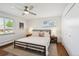 Well-lit bedroom with a ceiling fan, two windows, hardwood floors, and a double-door closet at 2774 S Milwaukee St, Denver, CO 80210
