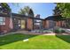 Inviting brick home entrance with manicured lawn and cozy outdoor seating at 2774 S Milwaukee St, Denver, CO 80210