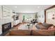 Inviting living room featuring a fireplace, hardwood floors, and ample natural light at 2774 S Milwaukee St, Denver, CO 80210