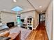 Living room with fireplace, skylight, wood floors, and view to backyard at 2774 S Milwaukee St, Denver, CO 80210