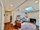 Cozy living room features a fireplace, skylight, and hardwood floors at 2774 S Milwaukee St, Denver, CO 80210
