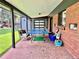 Covered brick patio with ping pong table and seating area, perfect for outdoor entertainment at 2774 S Milwaukee St, Denver, CO 80210