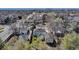 Wide aerial view of a residential neighborhood with a home featuring a detached garage and well-kept yard at 1108 Roslyn St, Denver, CO 80220