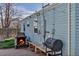 A charming outdoor area featuring a cozy fireplace, bench seating, BBQ, and stylish string lights at 1108 Roslyn St, Denver, CO 80220