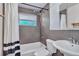 Bathroom with shower and tub combo, gray tile walls, toilet and single sink at 1108 Roslyn St, Denver, CO 80220