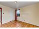 Bedroom featuring hardwood floors, a window, white door and light yellow walls at 1108 Roslyn St, Denver, CO 80220