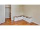 Bedroom featuring hardwood floors, a white corner bench seat and access to closet at 1108 Roslyn St, Denver, CO 80220
